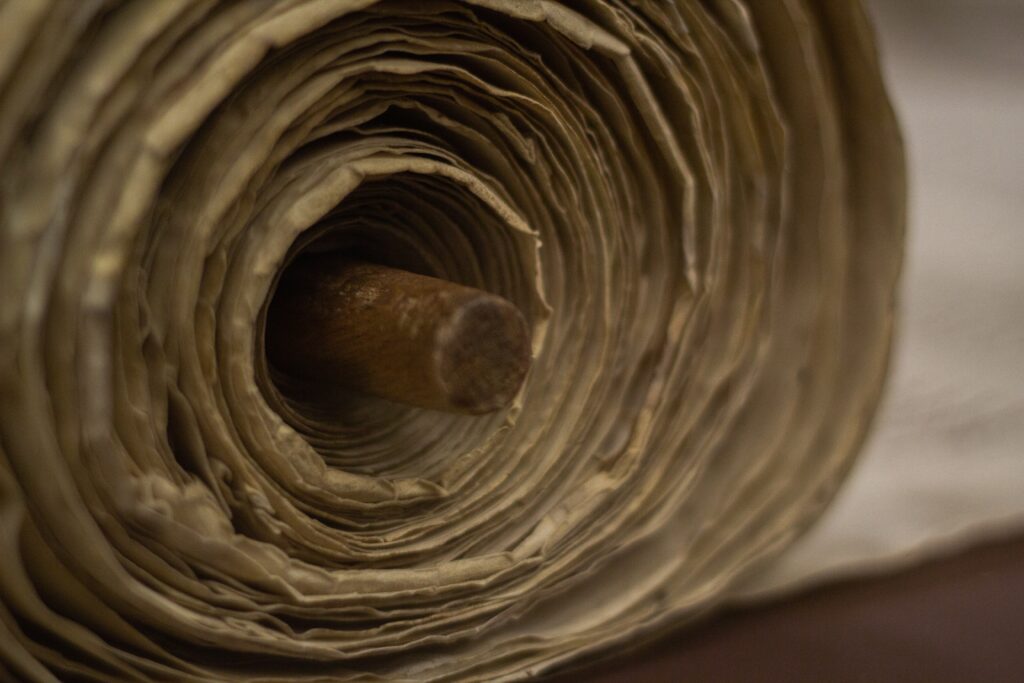 a close up of an old scroll being unwound
