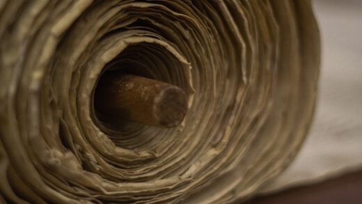 a close up of an old scroll being unwound