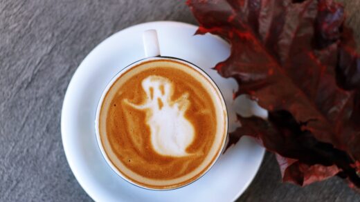 a coffee cup with a ghost as the espresso art